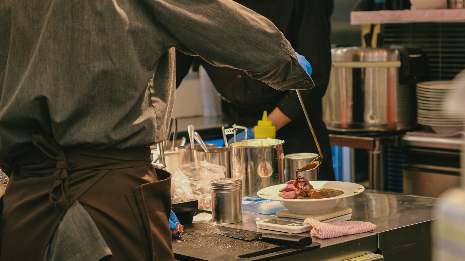 A tablet showing an online food ordering interface next to a restaurant counter